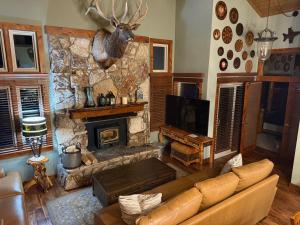 a living room with a couch and a stone fireplace at Mountainback 79 Loft Den in Mammoth Lakes