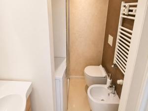 a small bathroom with a toilet and a sink at Blu Marina Alassio in Alassio +4 photos
