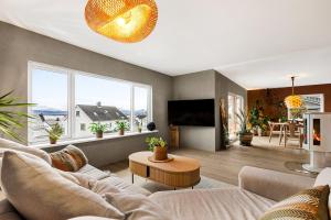 a living room with a couch and a table at Casa Formentera in Molde