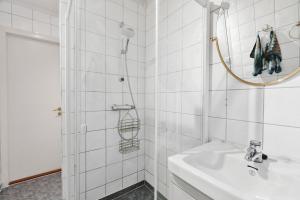 a white bathroom with a sink and a shower at Casa Formentera in Molde +13 photos