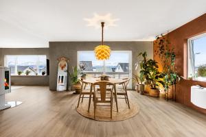 a dining room with a table and some plants at Casa Formentera in Molde