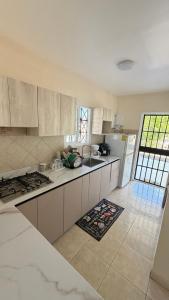 a kitchen with white cabinets and a counter top at Villa azuero in Los Santos