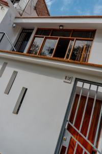 a facade of a white building with windows at Monoambiente 101 in Trujillo +5 photos