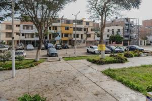 a parking lot with cars parked in front of buildings at Monoambiente 101 in Trujillo
