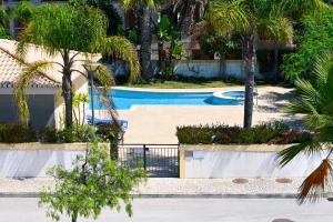 a swimming pool with palm trees in a resort at Lagos Stunning Apartments in Lagos