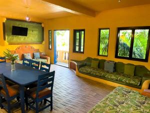 a living room with a couch and a table at Reef View Pavilions - Villas & Condos in Lance aux Épines