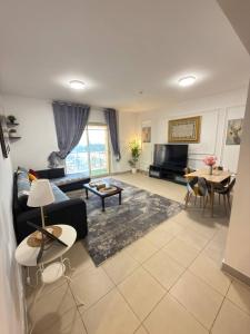 a living room with a couch and a table at شاطئ المرجان in King Abdullah Economic City