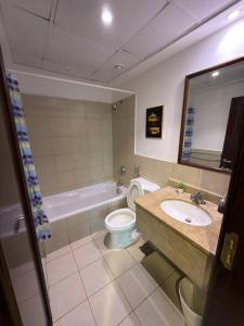 a bathroom with a sink and a toilet and a tub at شاطئ المرجان in King Abdullah Economic City