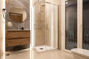 a shower with a glass door in a bathroom at Rural VillaReyes in Cabeza la Vaca