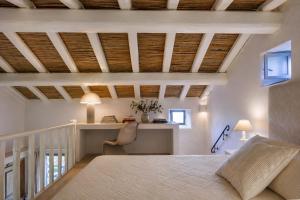 a bedroom with a bed and a desk in a room at Porto Cervo Sea and Nature Villa in Porto Cervo
