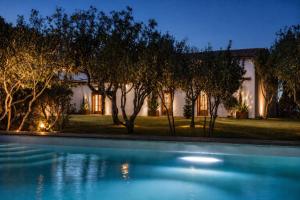 a house with a swimming pool at night at Porto Cervo Sea and Nature Villa in Porto Cervo