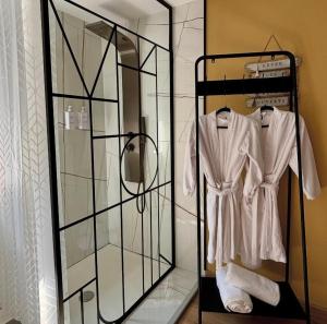 a glass display case with a white robe on it at Ô Saphir Spa - Maison N2 in Denain +6 photos