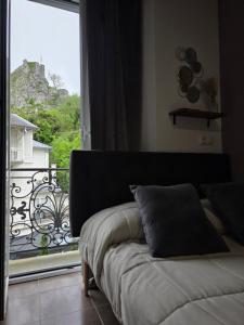 a couch in a room with a view of a balcony at Albatros in Lourdes
