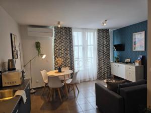 a living room with a table and a couch at Albatros in Lourdes +10 photos