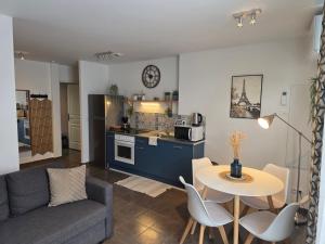 a living room with a couch and a table at Albatros in Lourdes