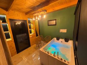 a large bathroom with a tub in a room at Alpine Cabins Gjinar in Gjinar