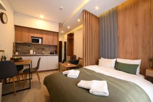a hotel room with a bed and a kitchen at Kopaonik Mountain Retreat in Cajetina +44 photos