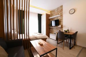 a living room with a table and a dining room at Kopaonik Mountain Retreat in Cajetina