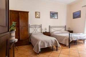 a bedroom with two beds and a table at Case Vacanze Albamarina in Lipari