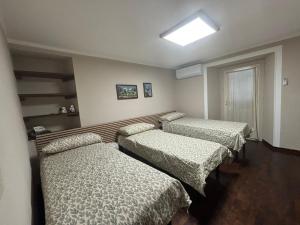 a room with three beds and a skylight at Casa Di Orfea in Perosa Argentina