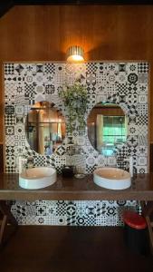 a bathroom with two sinks and a mirror at Sepilok Nature Lodge - Formerly known as Sepilok Nature Resort in Sandakan
