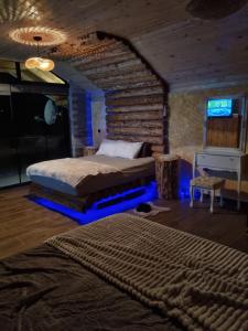 a bedroom with a bed in a room with blue lights at Villa Kristal Slatina- Private Pool & Jacuzzi BBQ in Slatina Varoš +50 photos