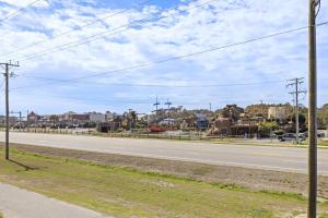 an empty street with a road with statues of elephants at 5085 - Knapp's at the Beach in Kill Devil Hills