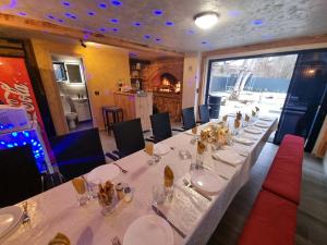 a dining room with a long table in a restaurant at Villa Kristal Slatina- Private Pool & Jacuzzi BBQ in Slatina Varoš