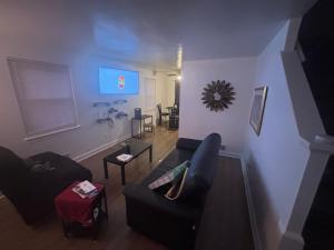 a living room with two couches and a tv at Peace & Relax sensation in Washington, D.C. +2 photos