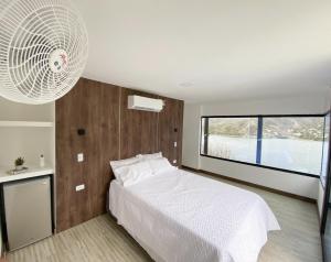 a bedroom with a white bed and a large window at Villa Malibu in Taganga +47 photos