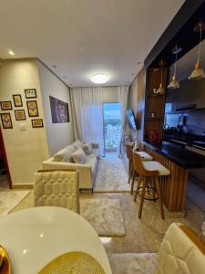 a living room with a couch and a table at Apartamento Confortável in Ananindeua