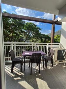 a purple table and chairs on a balcony at Tropical Escape at Pico De Loro in Nasugbu