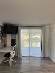 an office with a desk and a window at Water front Lake House in Okeechobee