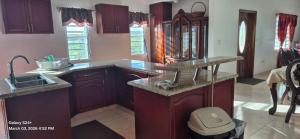 a kitchen with a sink and a counter top at Gumbsie Villas in The Valley