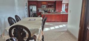 a kitchen with a table and chairs and a refrigerator at Gumbsie Villas in The Valley