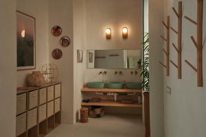 a bathroom with a sink and a mirror at OSA - Stella - Garden Hostel with bar in Naples +25 photos