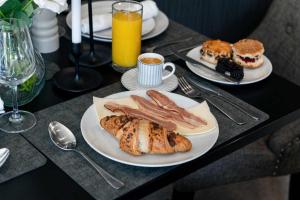 a table with two plates of breakfast foods and drinks at Stirling Riverview Apartment - Free Parking in Stirling