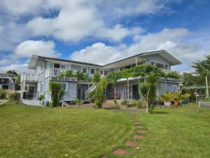 a large house with a lawn in front of it at Geyser Lookout BnB in Rotorua