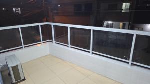 an empty balcony with a table and a bench at pajuçara R2 in Maceió