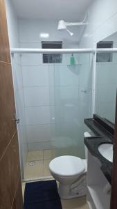 a bathroom with a shower with a toilet and a sink at pajuçara R2 in Maceió +20 photos