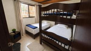 a small room with two bunk beds and a window at Salento verde in Salento