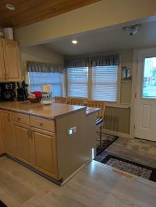 a kitchen with a large island in a room at Beach Cottage in Saco