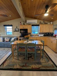a kitchen with a wooden table and chairs in a room at Beach Cottage in Saco