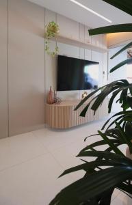 a living room with a flat screen tv on a wall at Sweet Home Away from yours in Lagoa Santa