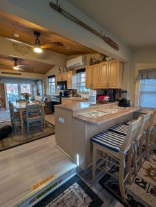 a kitchen with a counter and chairs in a room at Beach Cottage in Saco