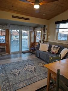 a living room with a couch and a table at Beach Cottage in Saco +45 photos