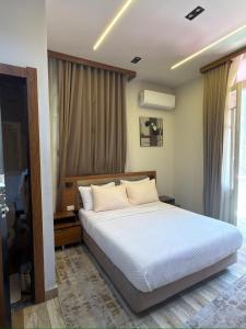 a bedroom with a white bed and a window at Italia Hotel Cairo in Cairo +147 photos