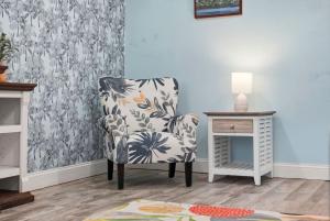 a room with a chair and a table with a lamp at Malibu Resort Motel in St. Pete Beach +80 photos