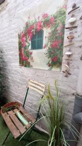 a chair sitting in front of a building with flowers at Liège City break in Liège