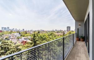 a balcony with a view of the city at Casa Taman by Kukun in Mexico City
